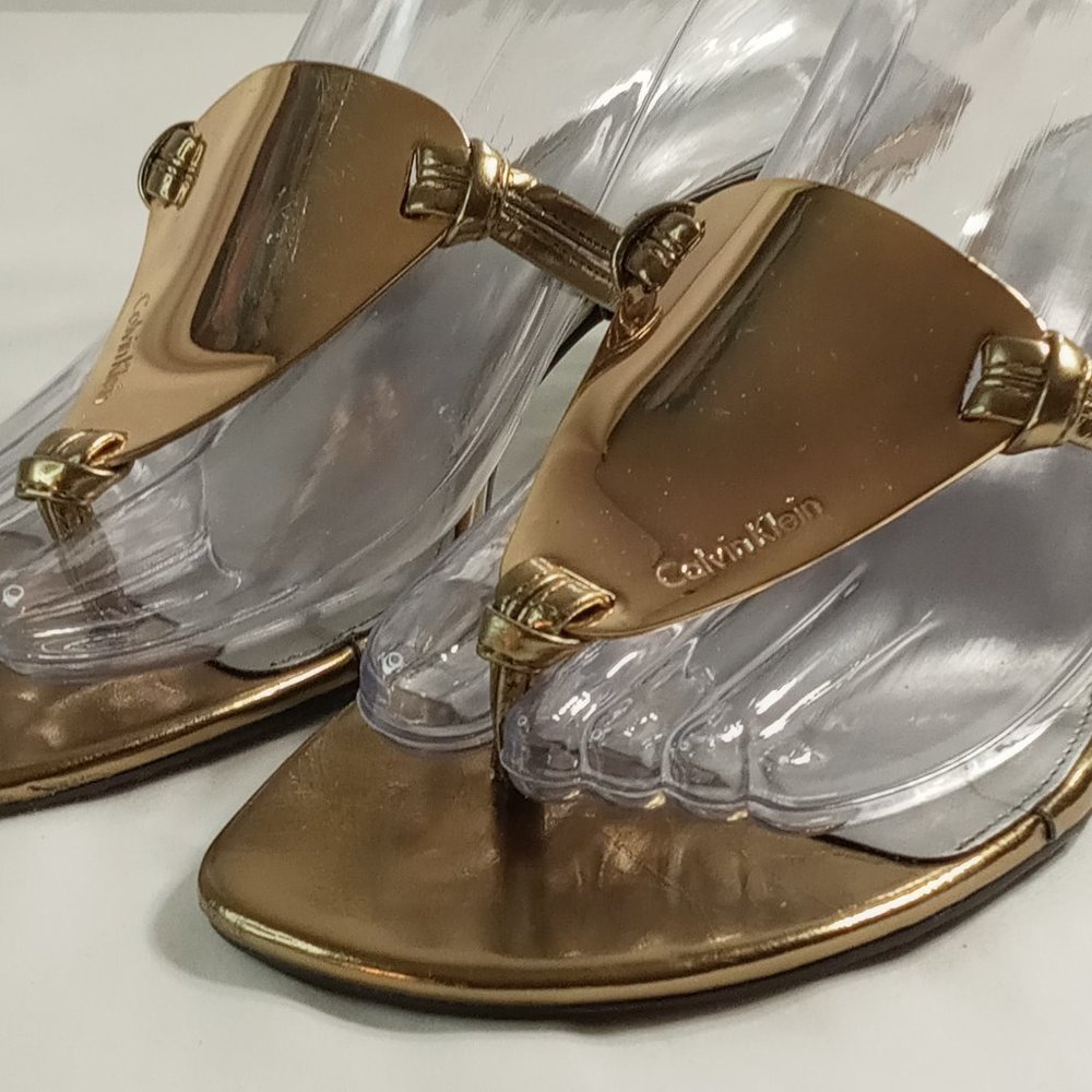 Calvin Klein Metal Top Plate Gold thong sandal.  Size 5 1/2M
